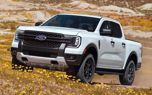 A white 2025 Ford Ranger driving through a field near Anderson, IN