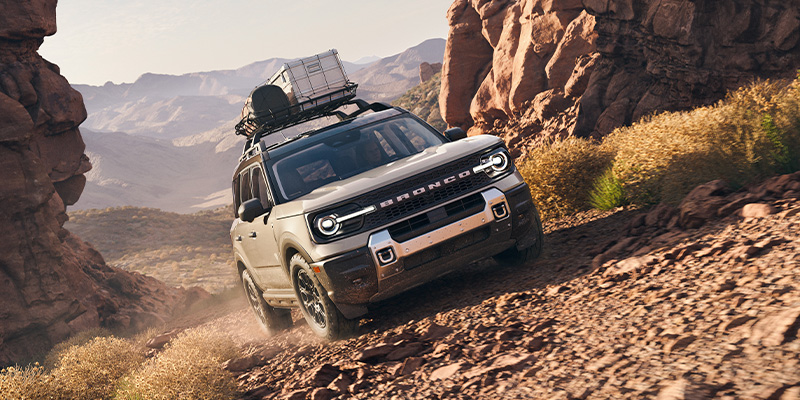 An all-new 2025 Ford Bronco Sport off-roading in the desert mountain terrain. - Ed Martin Ford Anderson, IN
