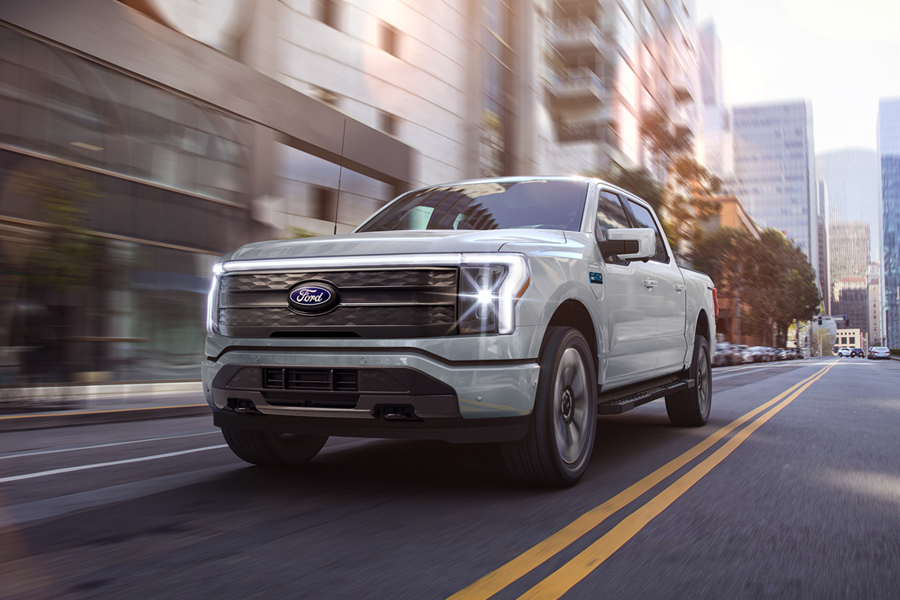An F-150 Lightning being driven in the city