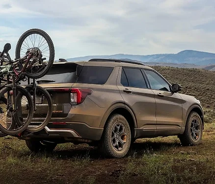 Ford Explorer with bicycles on a rear carrier parked by the water