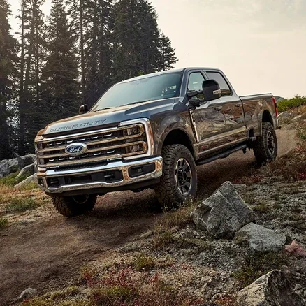 Ford Super Duty with the 7.3L V8 gas engine parked on a rocky forest hillside